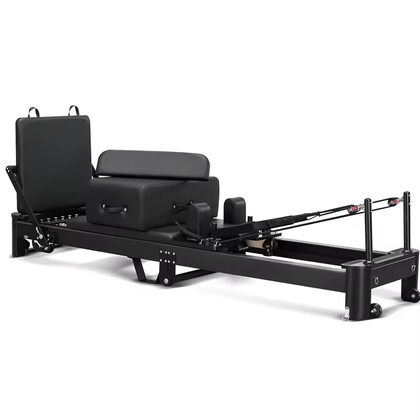 REFORMIA Onyx Foldable Pilates Reformer with Noir Black upholstery and matte black aluminium frame, three-quarter studio view
