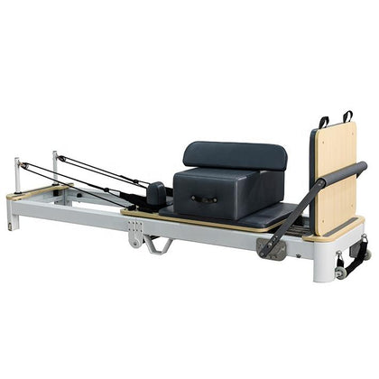 REFORMIA White Foldable Pilates Reformer with Black upholstery and white powder-coated aluminium frame, three-quarter studio view