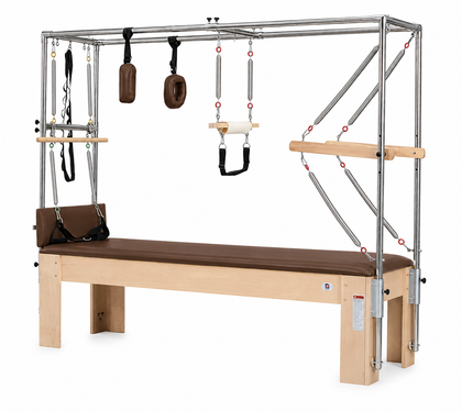 REFORMIA Maple Cadillac Pilates Reformer with tower, Black upholstery and solid wood frame, three-quarter studio view