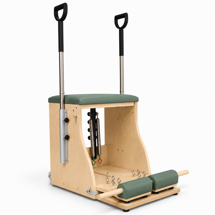 REFORMIA Pilates Wunda Chair in solid maple with Sage Green upholstery, three-quarter studio view